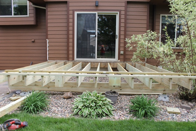 Inspiration for a small backyard ground level deck remodel with no cover