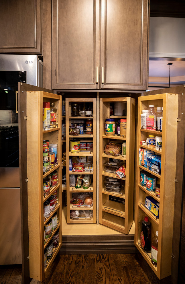 This is an example of a mid-sized modern l-shaped kitchen pantry in Atlanta with a single-bowl sink, flat-panel cabinets, dark wood cabinets, marble benchtops, multi-coloured splashback, subway tile splashback, stainless steel appliances, dark hardwood floors, with island, brown floor and blue benchtop.