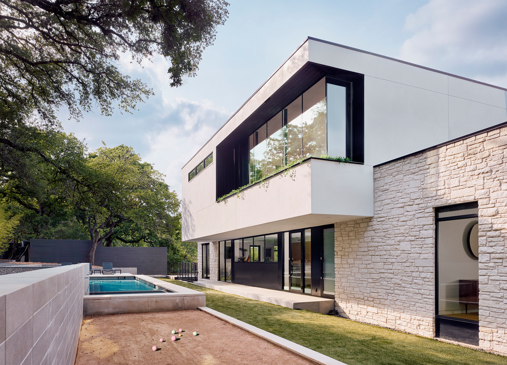 Inspiration for a contemporary backyard outdoor sport court in Austin with a retaining wall and concrete pavers.