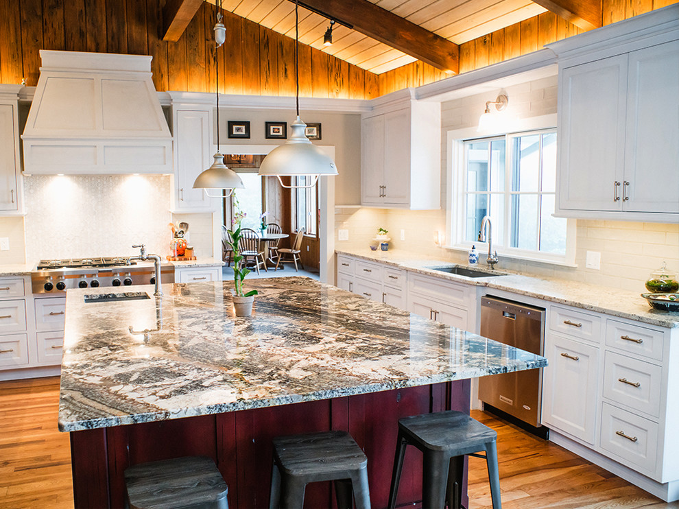 Large transitional u-shaped medium tone wood floor and brown floor eat-in kitchen photo with an undermount sink, white cabinets, granite countertops, white backsplash, ceramic backsplash, stainless steel appliances, an island and shaker cabinets
