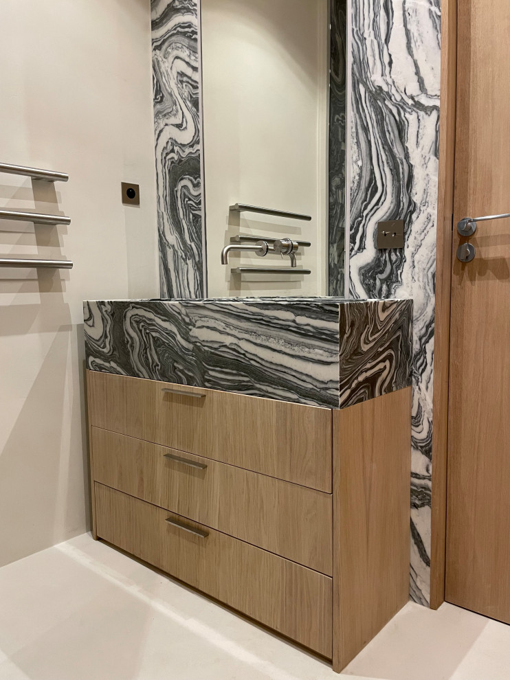 Medium sized contemporary ensuite bathroom in Paris with a built-in shower, a wall mounted toilet, marble tiles, concrete flooring, a trough sink, marble worktops, beige floors, a hinged door, a wall niche, a built in vanity unit and wood walls.