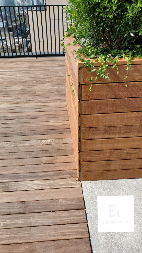This is an example of a large contemporary rooftop deck in New York with a container garden and no cover.