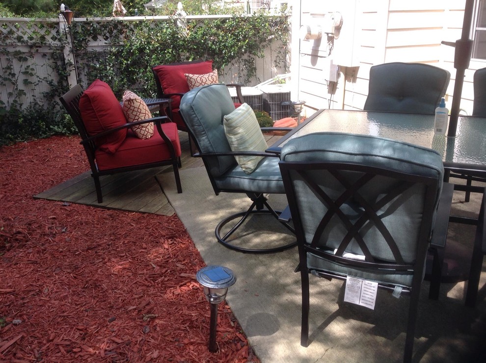 Inspiration for a small transitional backyard concrete patio remodel with no cover