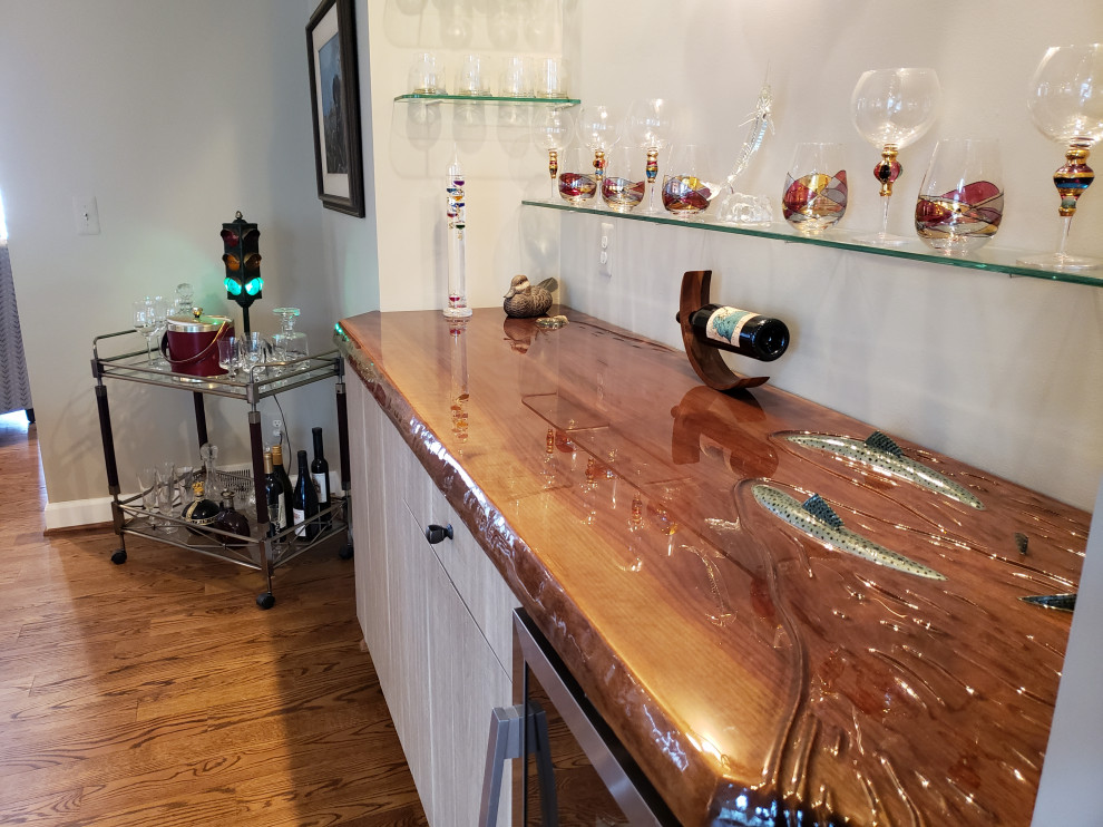 This is an example of a small eclectic single-wall home bar in Detroit with flat-panel cabinets, brown cabinets, wood benchtops and brown benchtop.