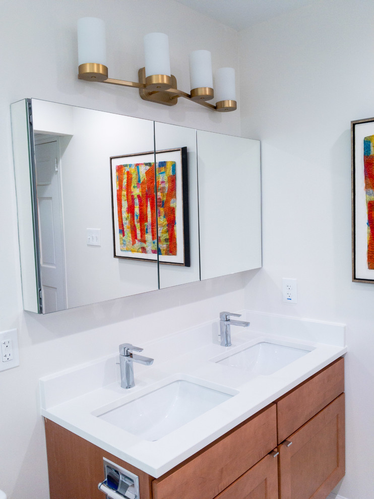 Inspiration for a small midcentury master bathroom in Raleigh with flat-panel cabinets, medium wood cabinets, an alcove shower, a one-piece toilet, gray tile, porcelain tile, mosaic tile floors, an undermount sink, engineered quartz benchtops, multi-coloured floor, a hinged shower door and white benchtops.