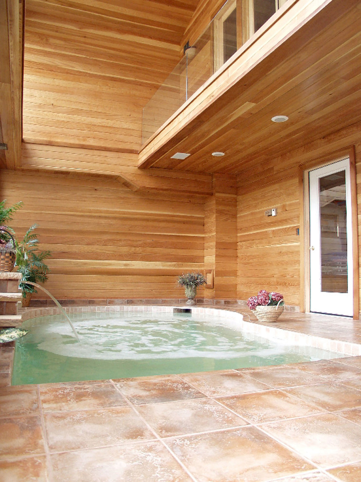 This is an example of a small contemporary indoor rectangular lap pool in San Diego with a hot tub and tile.