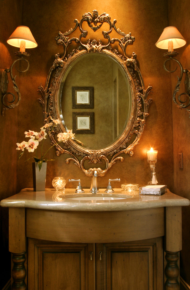 Photo of a mid-sized traditional powder room in Tampa with an undermount sink, furniture-like cabinets, light wood cabinets, brown walls, granite benchtops and beige benchtops.