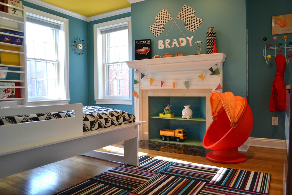 This is an example of a mid-sized contemporary kids' bedroom for boys and kids 4-10 years old in Boston with blue walls and medium hardwood floors.