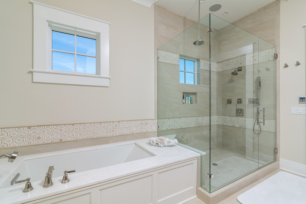 Inspiration for a large beach style master bathroom in Birmingham with recessed-panel cabinets, white cabinets, an undermount tub, a corner shower, a two-piece toilet, beige walls, limestone floors, an undermount sink and marble benchtops.