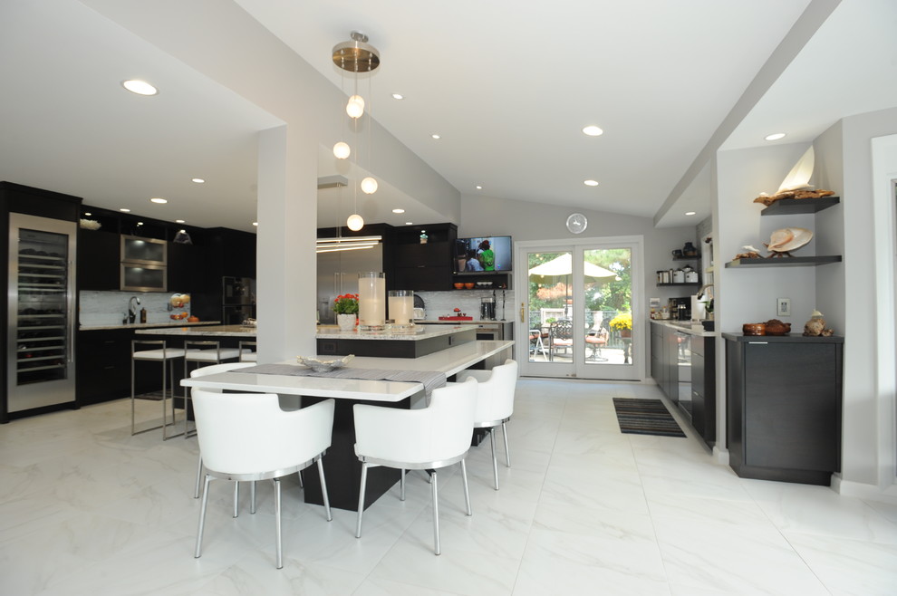 Inspiration for an expansive modern l-shaped eat-in kitchen in Atlanta with an undermount sink, dark wood cabinets, quartz benchtops, stainless steel appliances, porcelain floors, with island, flat-panel cabinets, grey splashback, matchstick tile splashback and white floor.
