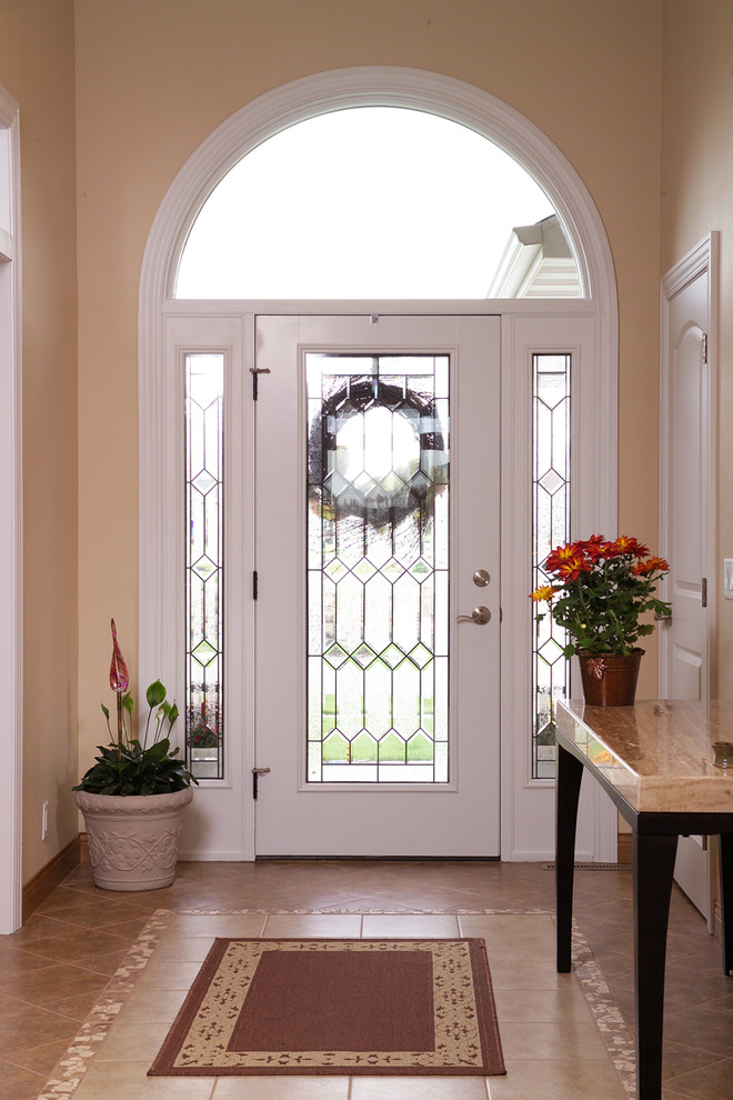 Mid-sized transitional porcelain tile home design photo with beige walls and a white front door