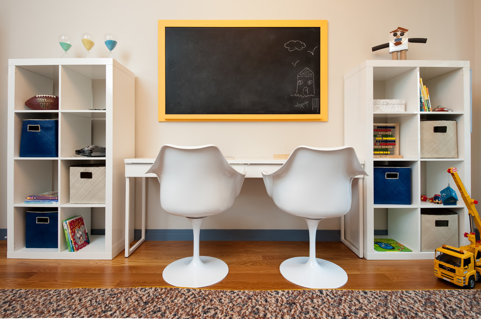 Inspiration for a study space and mid-sized transitional boy medium tone wood floor kids' study room remodel in New York with beige walls
