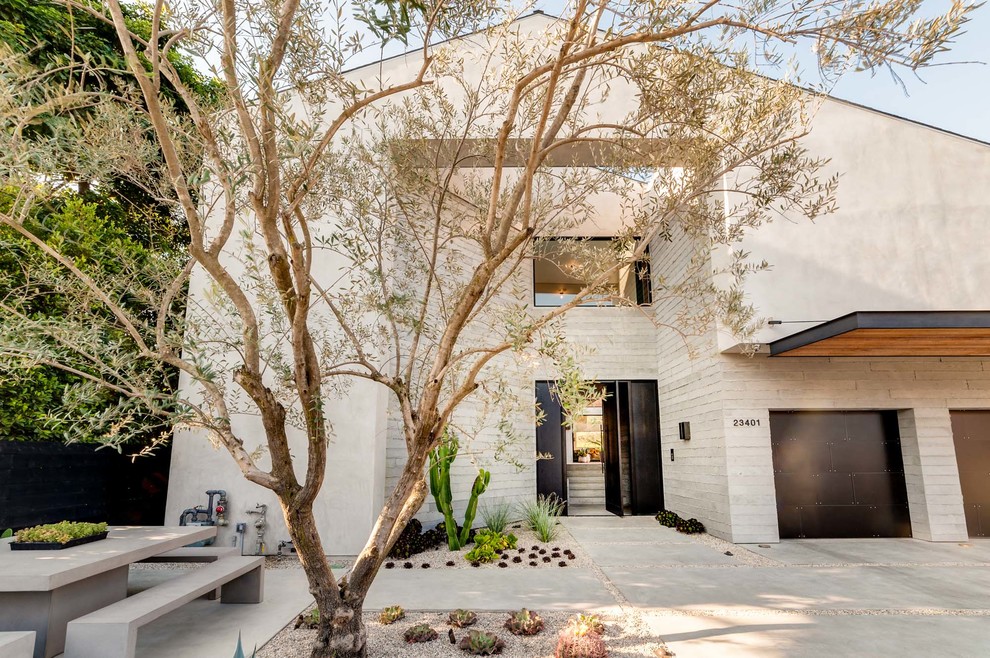 Expansive contemporary split-level grey house exterior in Los Angeles with mixed siding.