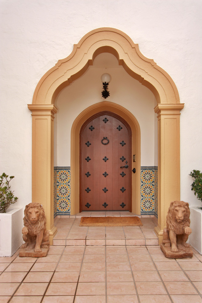 Design ideas for a mediterranean front door in San Diego with a single front door and a medium wood front door.