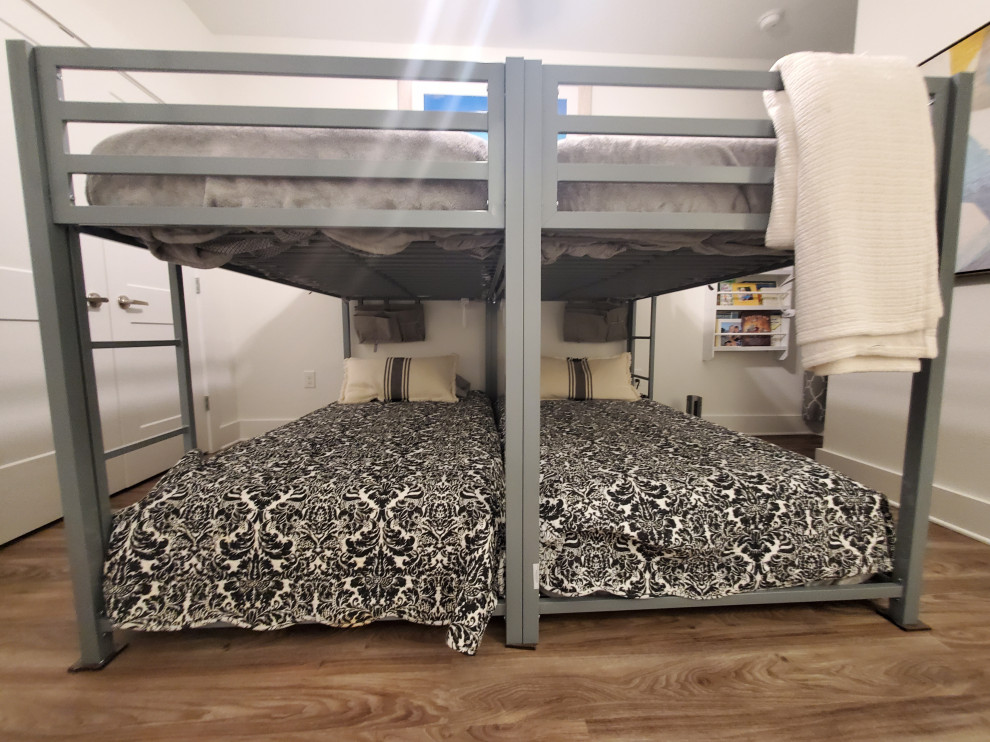 Example of a mid-sized transitional guest vinyl floor and beige floor bedroom design with white walls