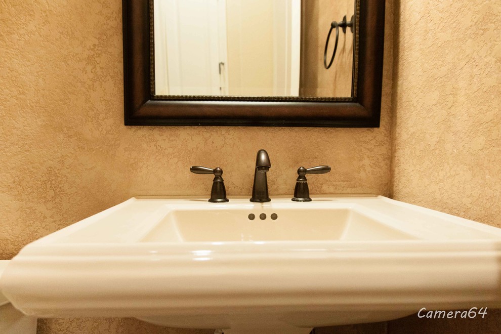 Small traditional 3/4 bathroom in Austin with a pedestal sink, a corner tub, a two-piece toilet and travertine floors.