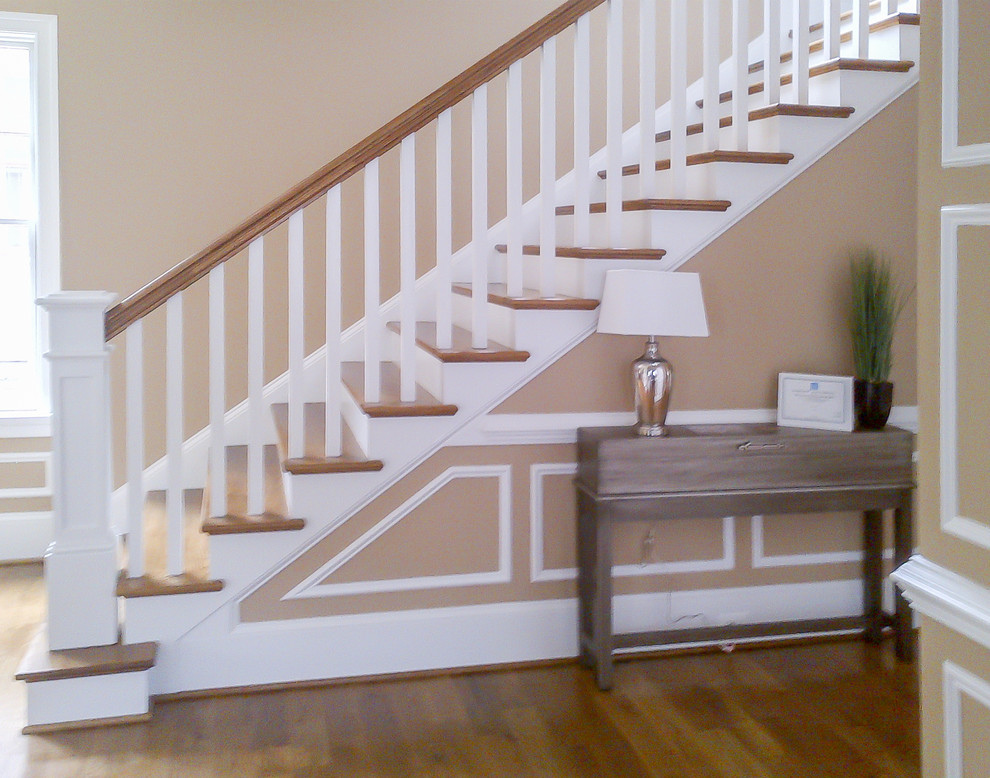 Design ideas for a mid-sized arts and crafts wood straight staircase in DC Metro with wood risers and wood railing.