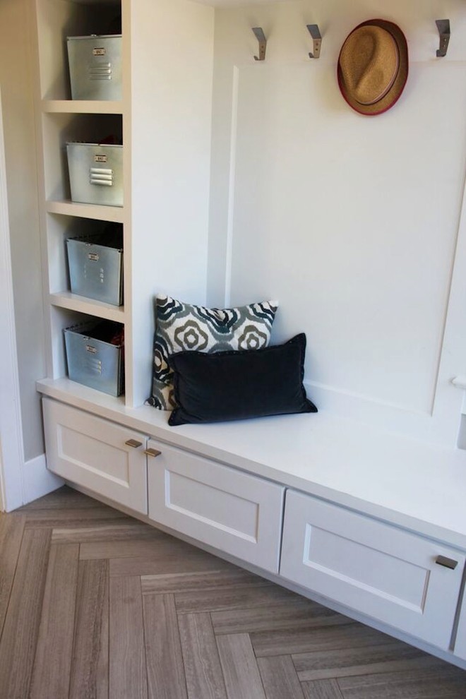 This is an example of a mid-sized contemporary mudroom in Denver with grey walls and limestone floors.
