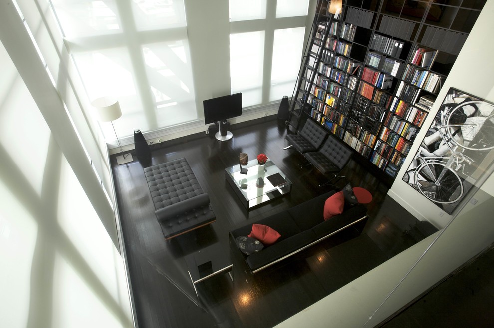 This is an example of a contemporary living room in Boston with a library, no fireplace and a freestanding tv.