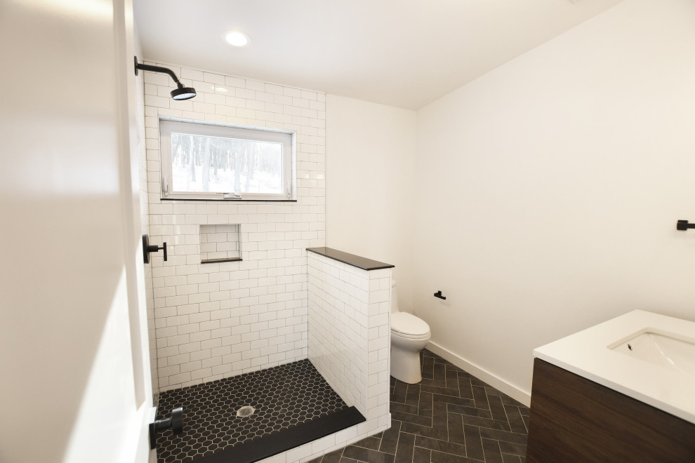 Design ideas for a mid-sized midcentury kids bathroom in New York with furniture-like cabinets, medium wood cabinets, a corner shower, a one-piece toilet, white tile, ceramic tile, white walls, ceramic floors, a drop-in sink, grey floor and a shower curtain.