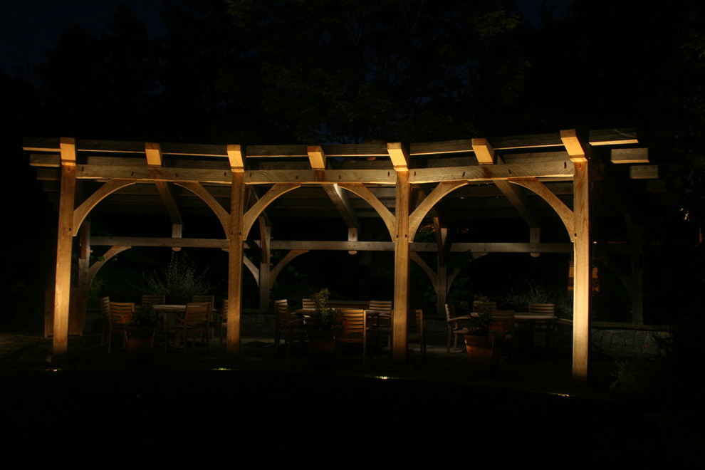Design ideas for a traditional patio in Portland with natural stone pavers and a pergola.