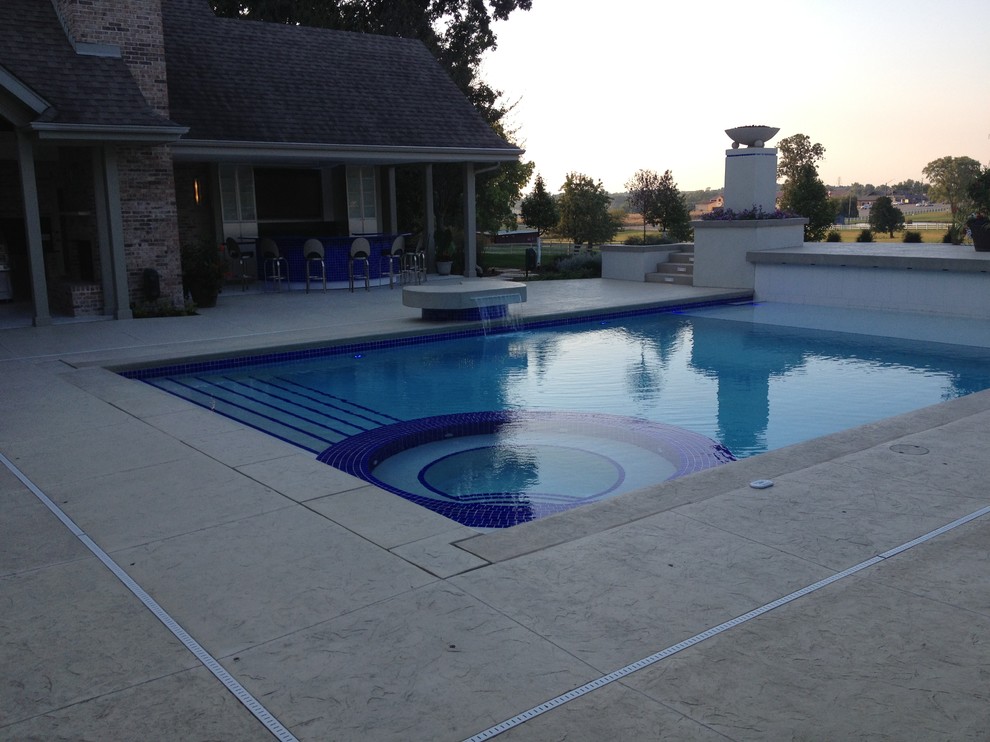 Example of a large transitional backyard concrete paver and rectangular natural hot tub design in Cedar Rapids