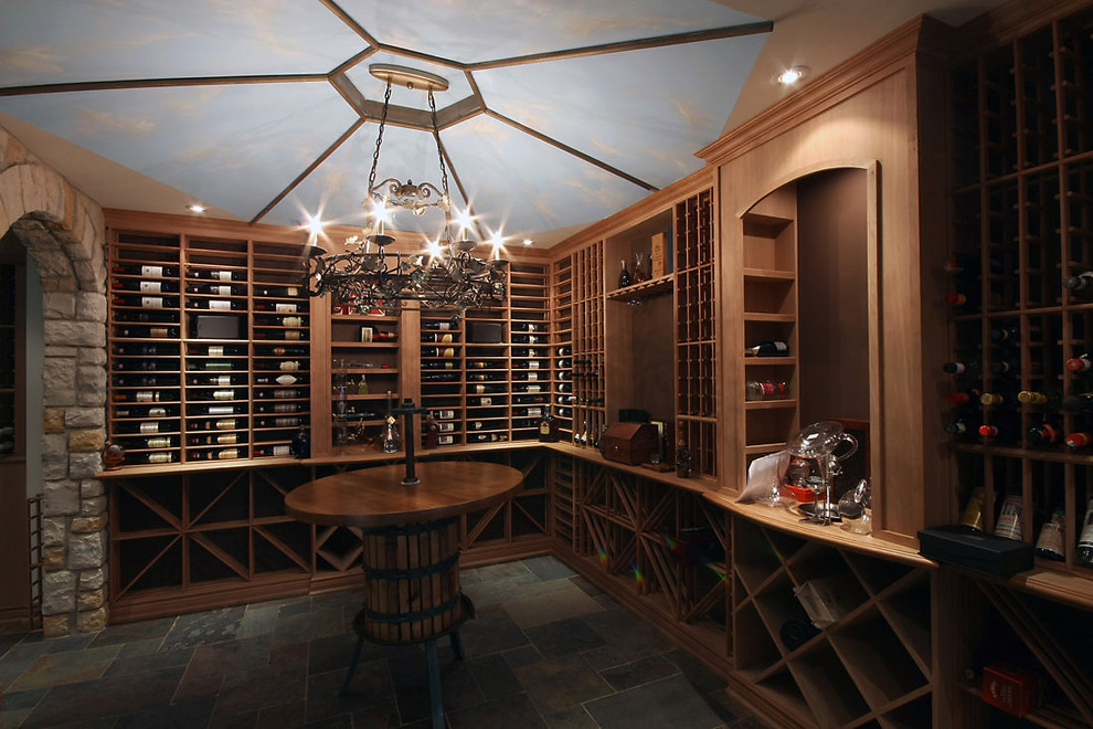 Inspiration for a large traditional wine cellar in Toronto with slate floors, display racks and grey floor.