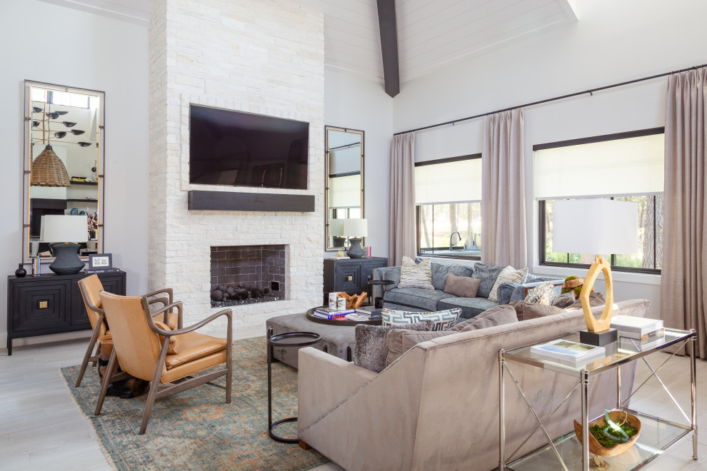 Large beach style open concept beige floor, shiplap ceiling and porcelain tile living room photo in Houston with a standard fireplace, a wall-mounted tv, white walls and a stacked stone fireplace