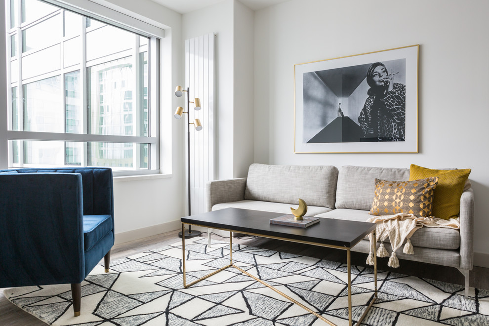 Photo of a contemporary formal living room in San Francisco with white walls, light hardwood floors and brown floor.