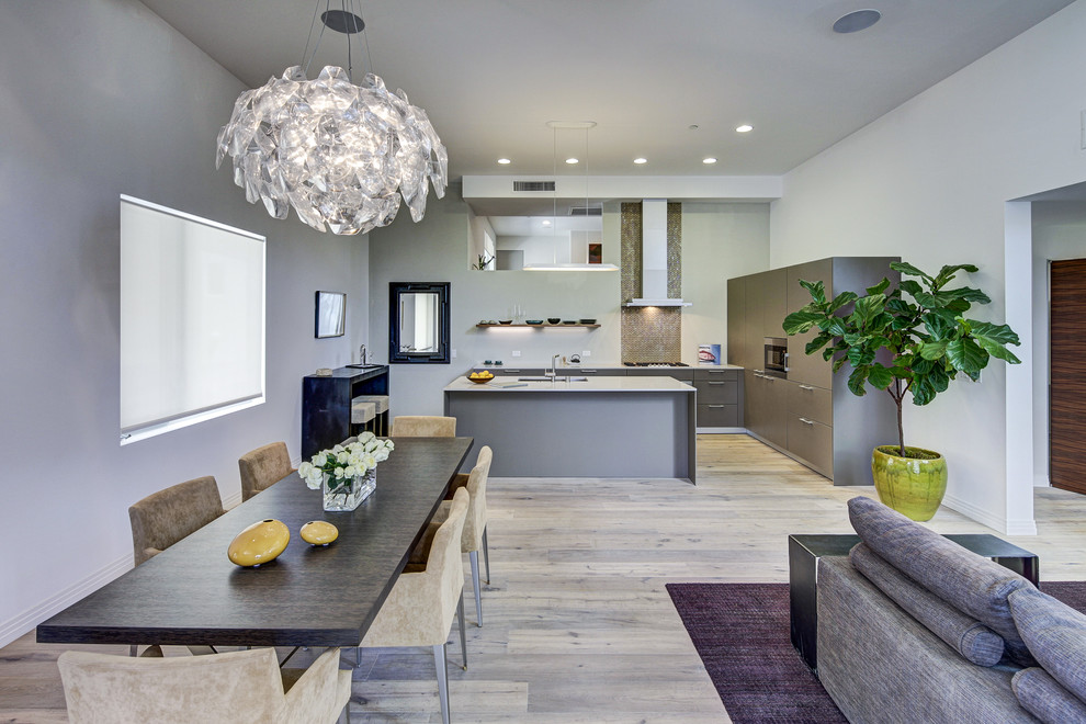Contemporary open plan dining in Los Angeles with grey walls and medium hardwood floors.