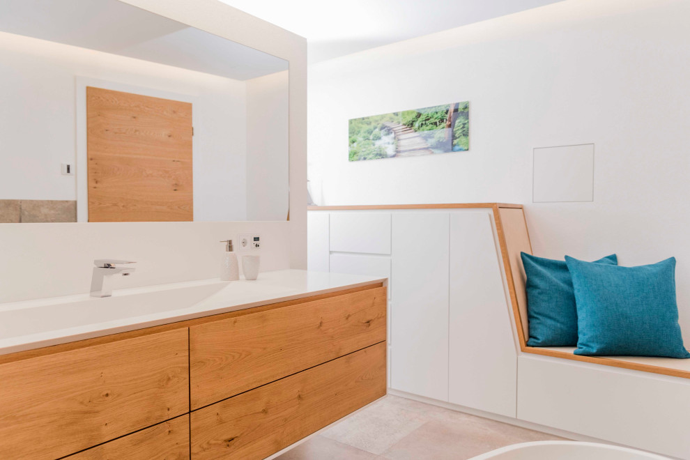 Photo of a mid-sized contemporary bathroom in Munich with a freestanding tub, a drop-in sink, solid surface benchtops, white benchtops, a single vanity and a built-in vanity.