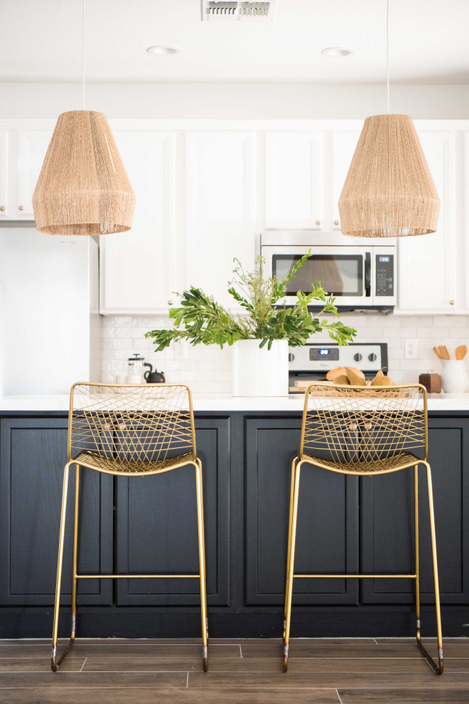 Mid-sized transitional l-shaped open concept kitchen photo in Phoenix with white backsplash, ceramic backsplash, stainless steel appliances and an island