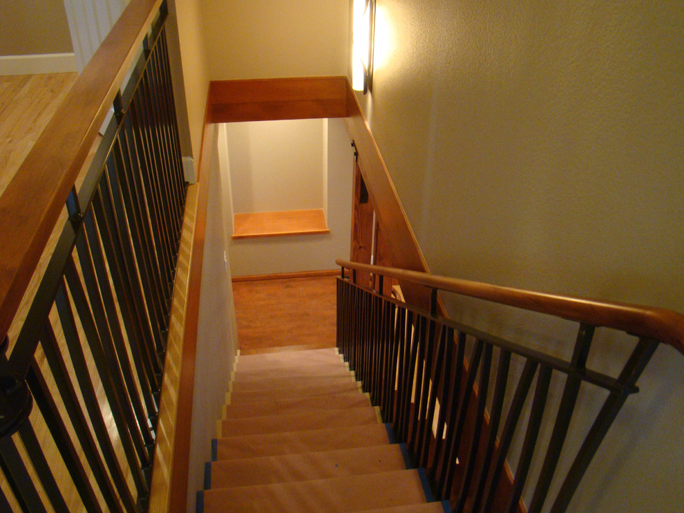 Photo of a mid-sized arts and crafts carpeted straight staircase in Denver with carpet risers.
