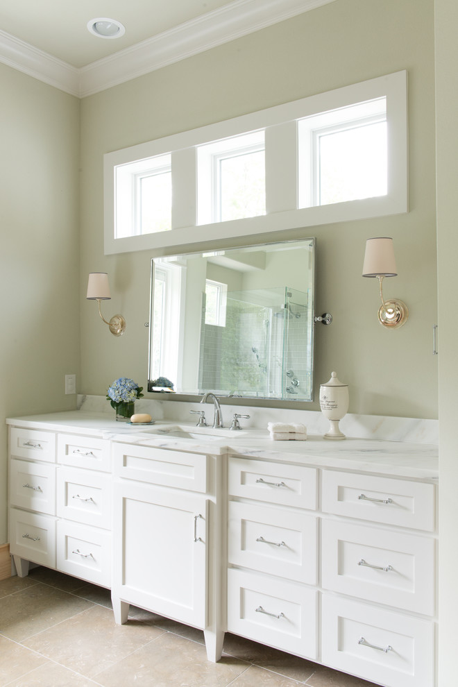 Photo of a country bathroom in Dallas with shaker cabinets, white cabinets and beige walls.