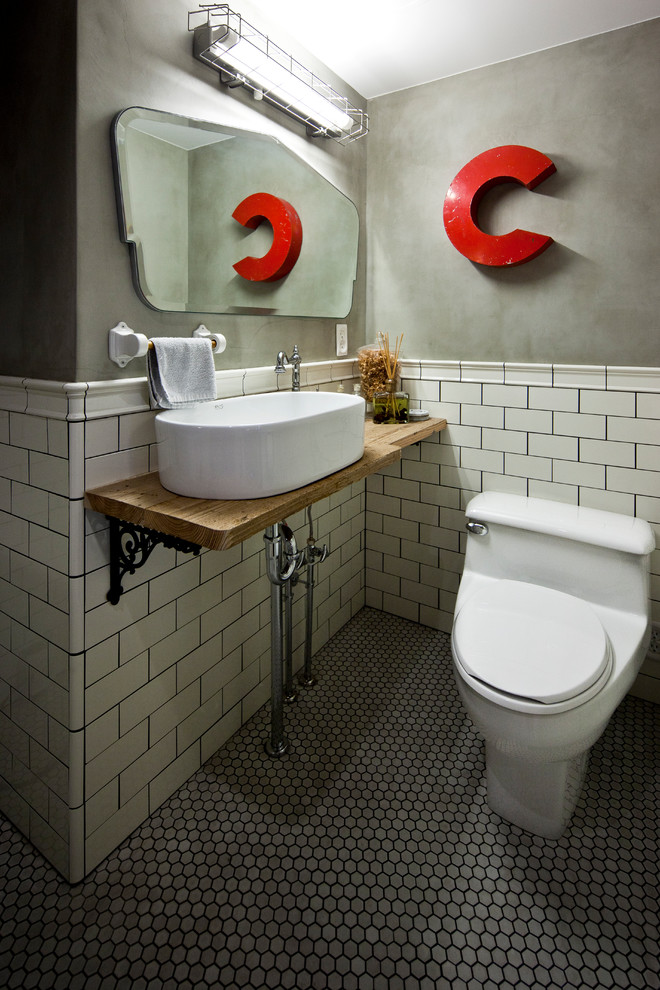 Industrial powder room in Tokyo with white tile, subway tile, grey walls, a vessel sink and grey floor.