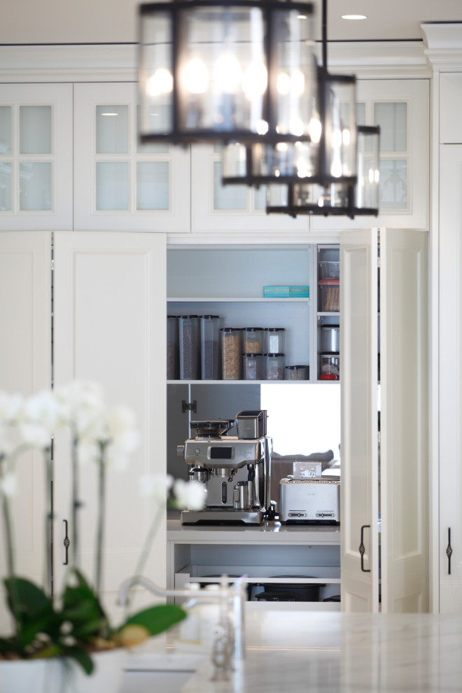 Inspiration for a traditional kitchen pantry in Sydney with recessed-panel cabinets, white cabinets, marble benchtops, mirror splashback and white benchtop.