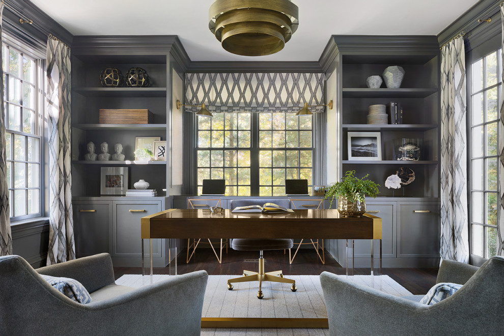 Inspiration for a transitional home office in New York with grey walls, dark hardwood floors, a freestanding desk and brown floor.