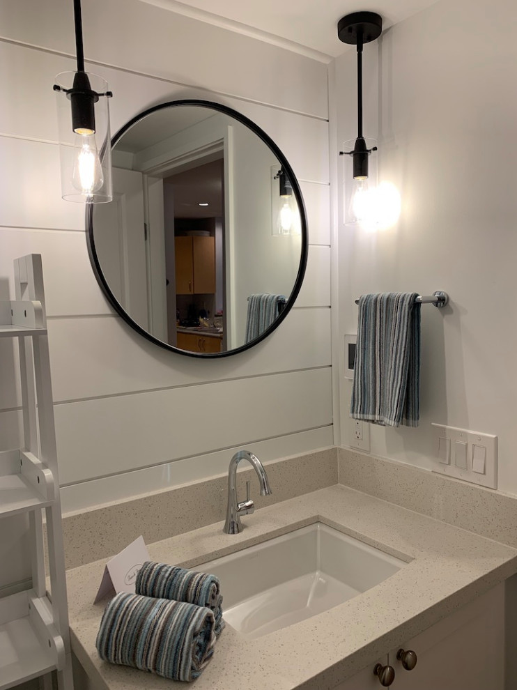 This is an example of a small transitional 3/4 bathroom in Vancouver with shaker cabinets, white cabinets, an alcove shower, a one-piece toilet, blue tile, ceramic tile, white walls, porcelain floors, an undermount sink, quartzite benchtops, grey floor, a hinged shower door, white benchtops, a single vanity, a floating vanity and planked wall panelling.
