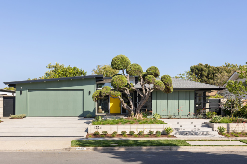 Design ideas for a midcentury one-storey green house exterior in Orange County with a hip roof, a shingle roof, a grey roof and board and batten siding.