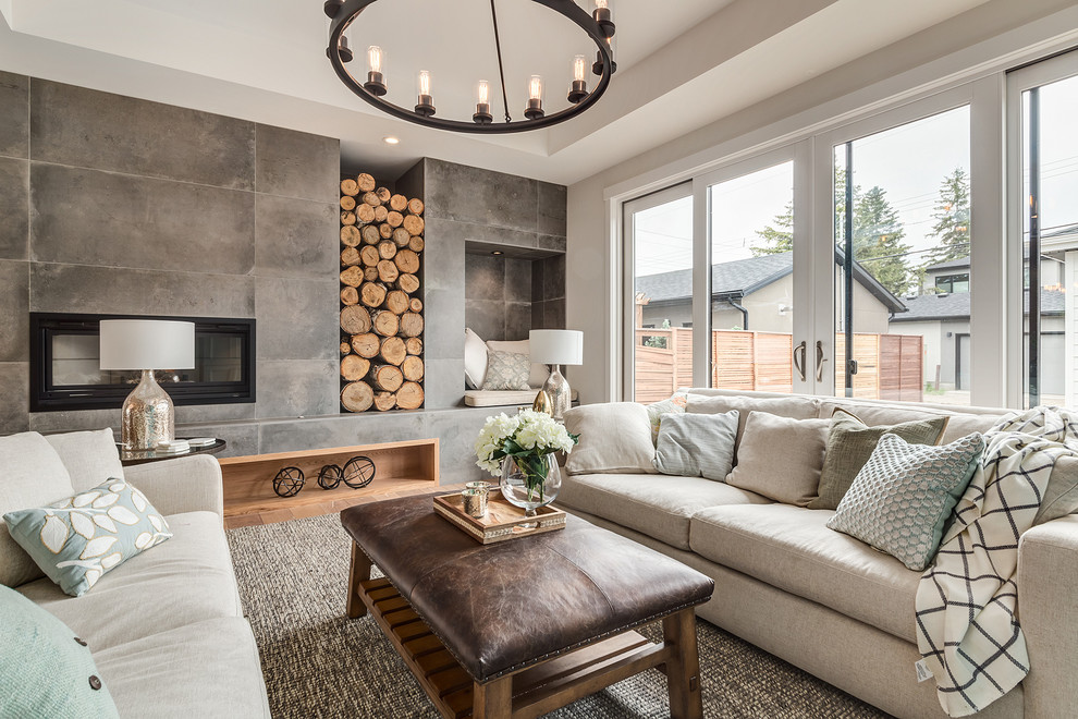 This is an example of a large country open concept living room in Calgary with white walls, light hardwood floors, a wood stove, a tile fireplace surround, a concealed tv and beige floor.
