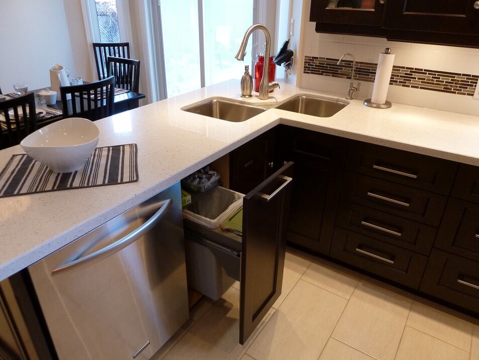 Transitional porcelain tile and beige floor eat-in kitchen photo in Toronto with a double-bowl sink, shaker cabinets, dark wood cabinets, quartz countertops, white backsplash, subway tile backsplash, stainless steel appliances and white countertops