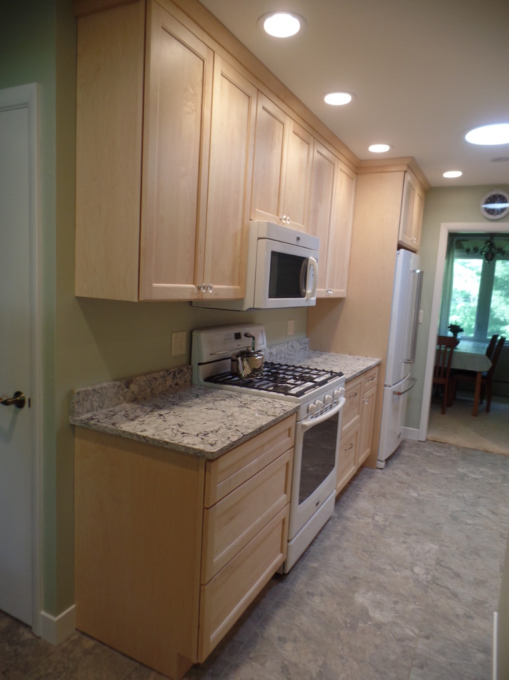 Mid-sized transitional galley vinyl floor eat-in kitchen photo in Cedar Rapids with an undermount sink, shaker cabinets, light wood cabinets, quartz countertops, white appliances and no island