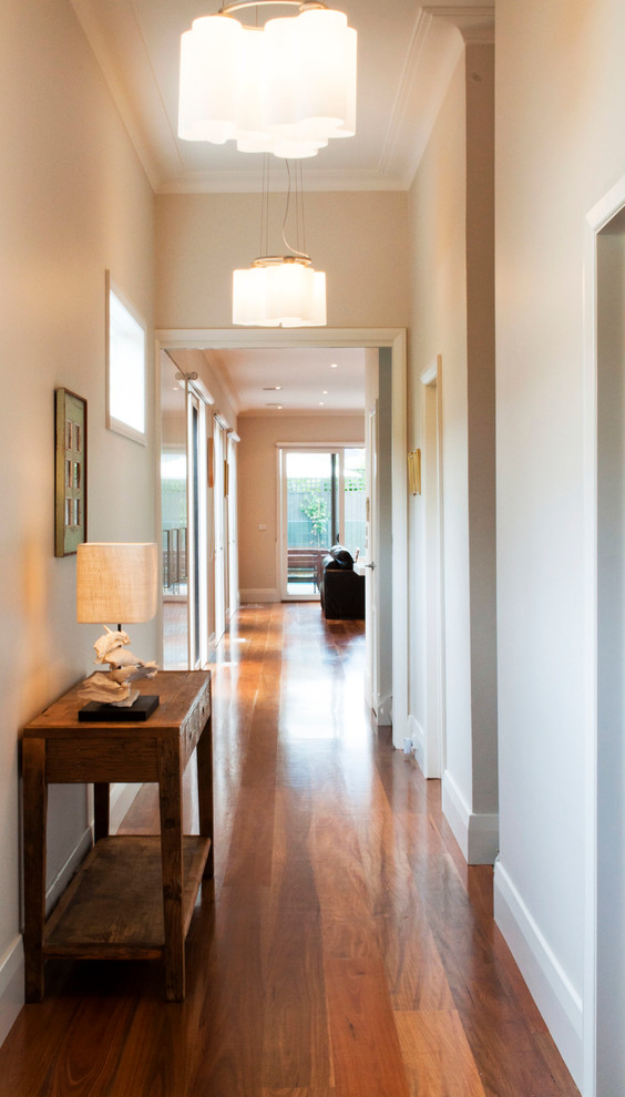 Photo of a large contemporary hallway in Melbourne with white walls and medium hardwood floors.