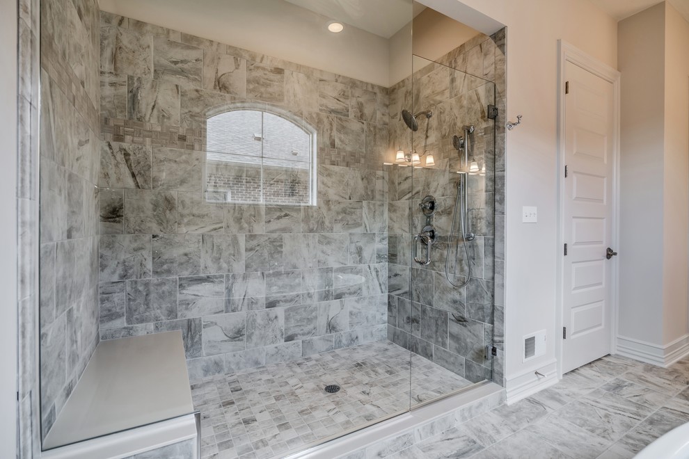 Large transitional master beige tile and ceramic tile ceramic tile and brown floor freestanding bathtub photo with flat-panel cabinets, gray cabinets, a two-piece toilet, beige walls, an undermount sink, quartz countertops, a hinged shower door and beige countertops