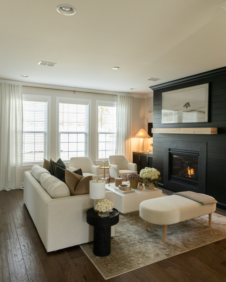 На фото: открытая гостиная комната среднего размера в стиле модернизм с серыми стенами, полом из ламината, стандартным камином, фасадом камина из вагонки, телевизором на стене и коричневым полом с