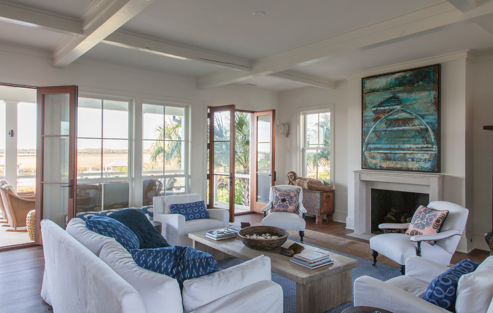 Photo of a beach style open concept living room in Charleston with white walls, dark hardwood floors, a standard fireplace and a stone fireplace surround.