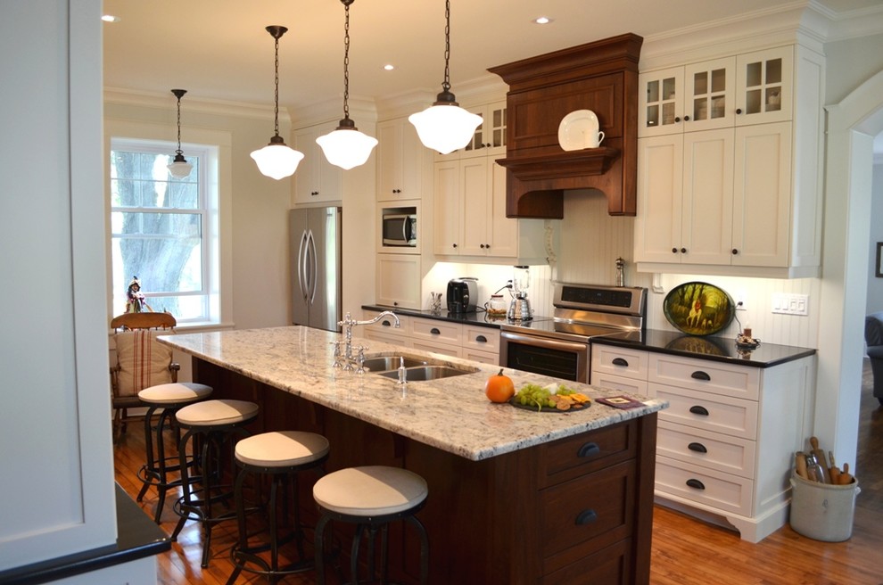 Large single-wall medium tone wood floor eat-in kitchen photo in Ottawa with a double-bowl sink, raised-panel cabinets, white cabinets, white backsplash, stainless steel appliances and an island
