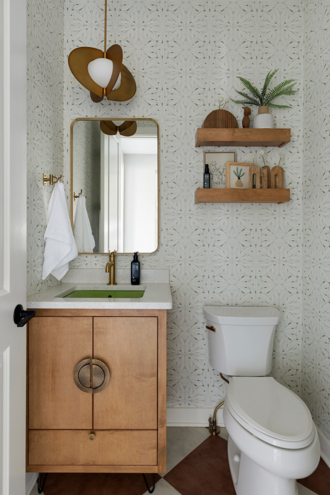 Inspiration for a transitional multicolored floor and wallpaper powder room remodel in Minneapolis with flat-panel cabinets, medium tone wood cabinets, multicolored walls, an undermount sink, white countertops and a floating vanity