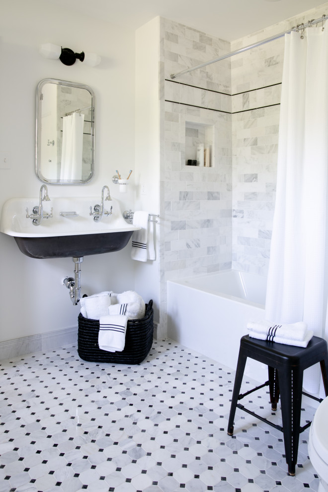 Photo of a small transitional kids bathroom in New York with an alcove tub, a shower/bathtub combo, white tile, marble, white walls, marble floors, a trough sink, white floor, a shower curtain, a double vanity and a niche.