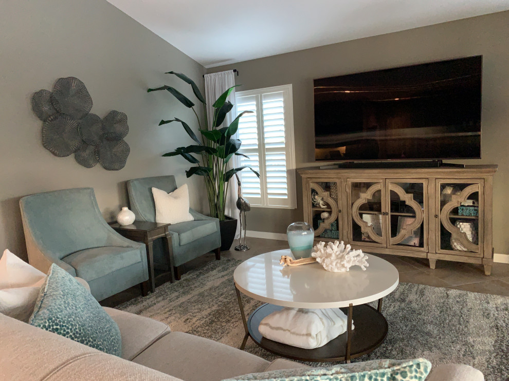This is an example of a mid-sized beach style family room in Orlando with grey floor.